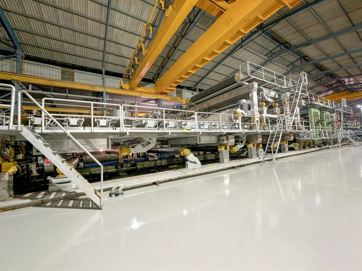 Paper machine at a mill fed by clean stock from a paper recycling machine line
